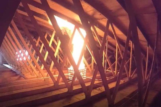 Fire spreading through a timber roof space above a ceiling
