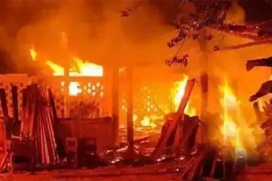 A building engulfed in flames at night, the kind of scene a fire accident investigation examines