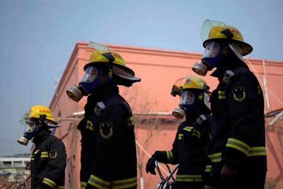 Four firefighters in full protective equipment and breathing apparatus